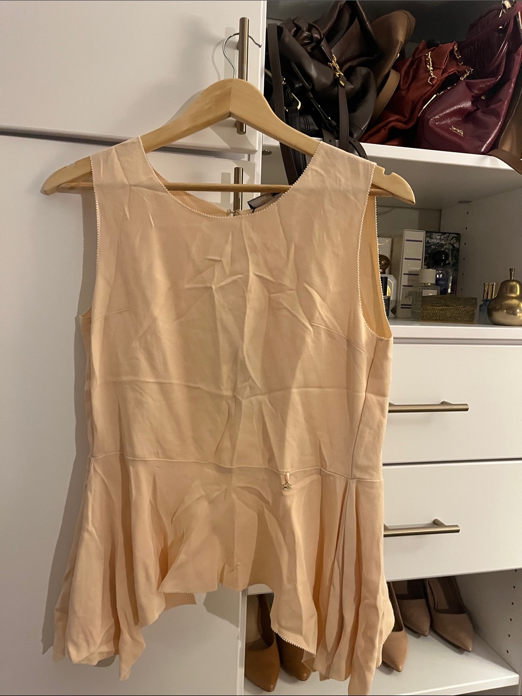 Sleeveless Peplum Top In Light Peach